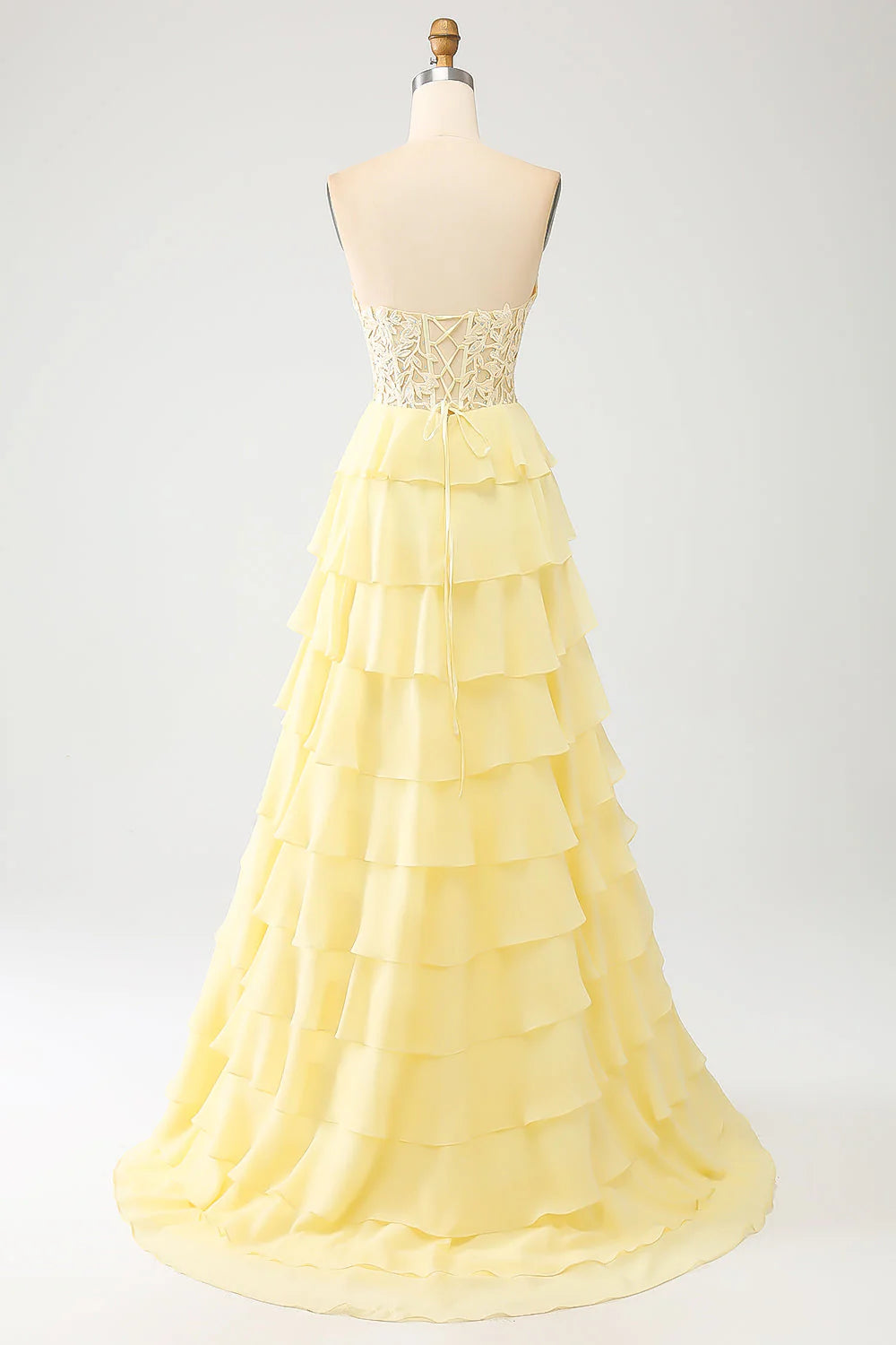Elegant formal gown with tiered skirt detail.