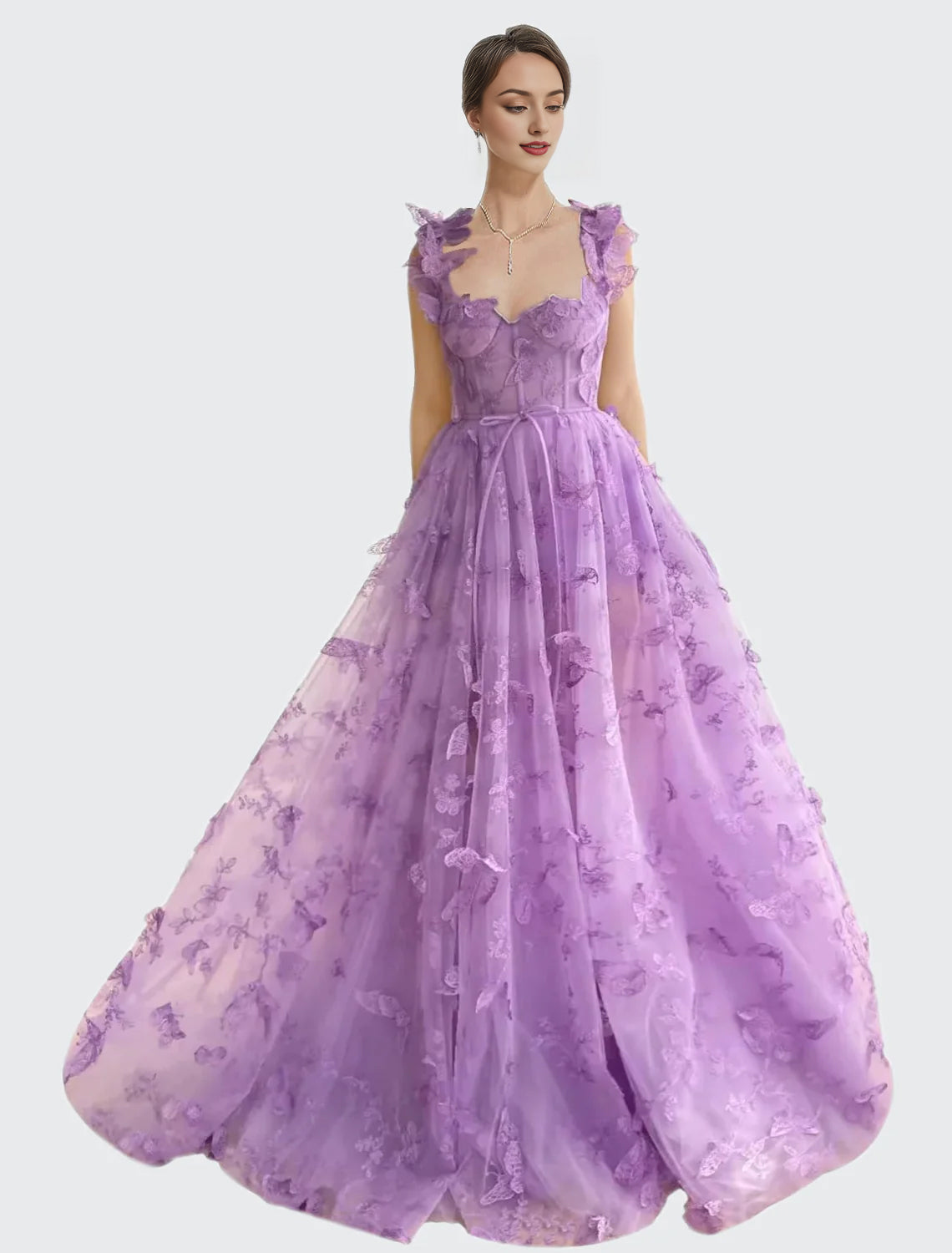 Model in a pink tulle ball gown with 3D butterflies and a high slit.