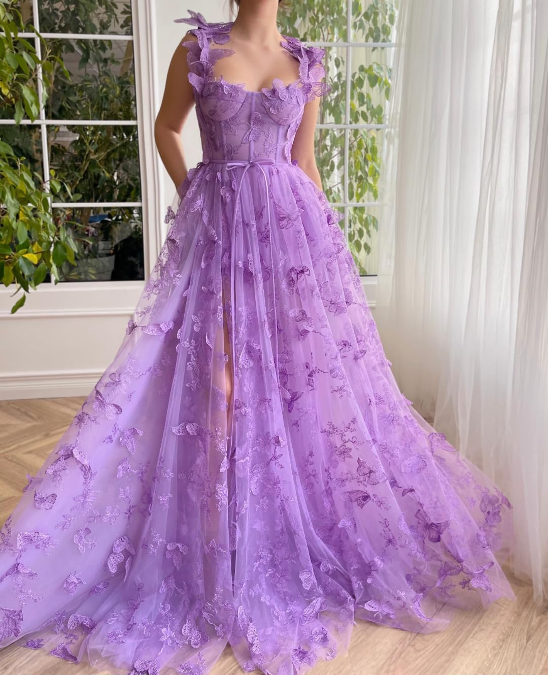 Back view of the pink tulle ball gown, showcasing its flowing train.
