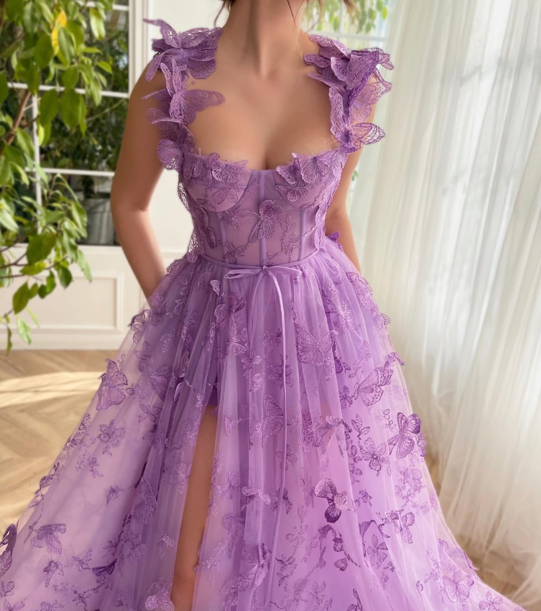 Model in a pink tulle ball gown, showing the strapless sweetheart neckline.
