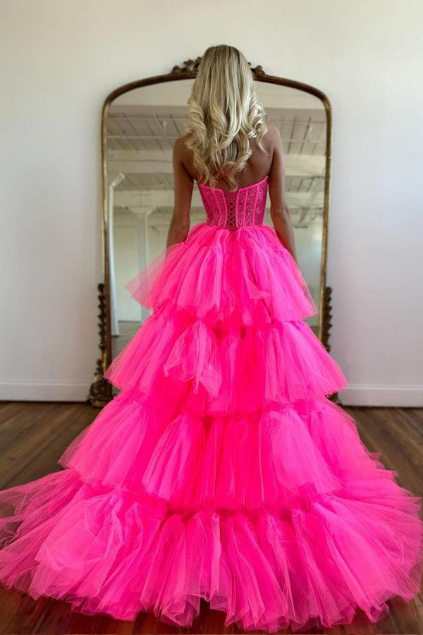 Full view of a hot pink tiered high-low evening dress.