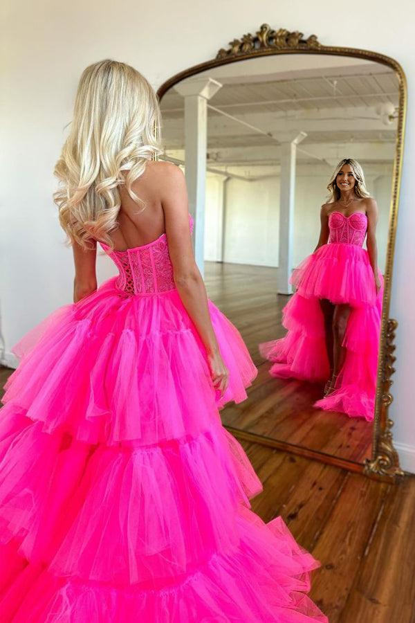 Back view of the hot pink high-low tiered prom dress.