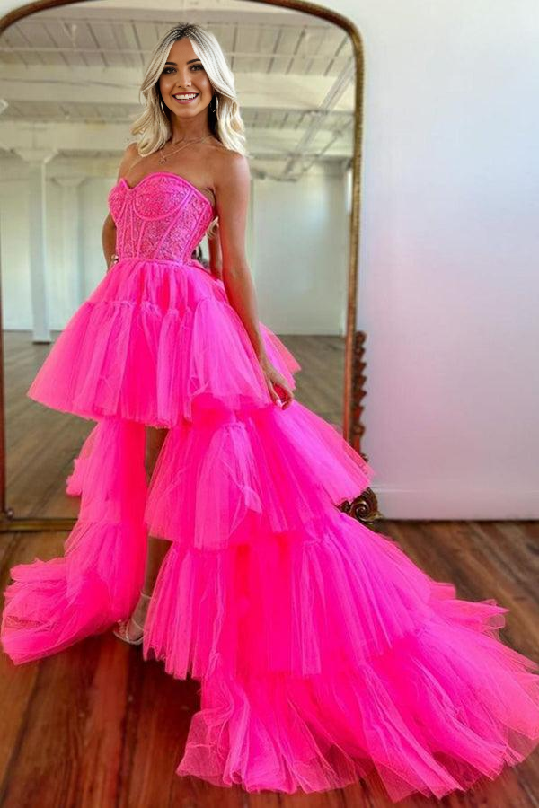 Side profile of a woman wearing the hot pink high-low tiered dress.