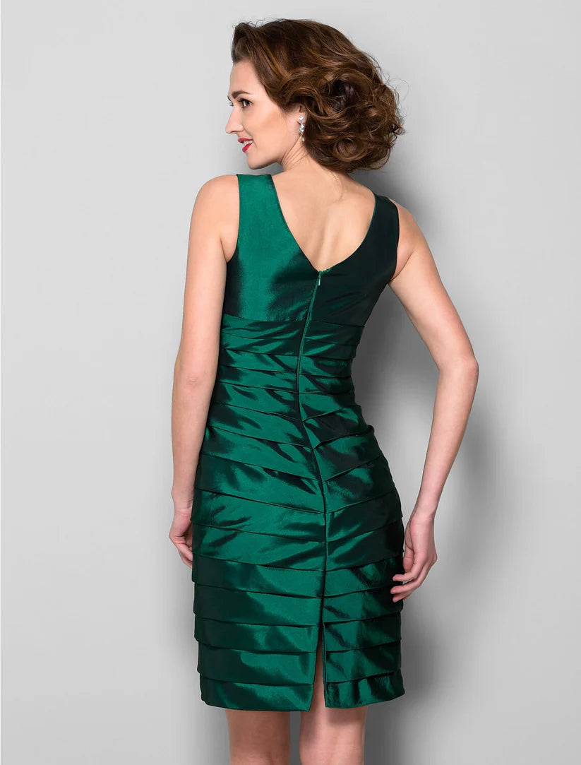 Full-length view of a woman gracefully posing in the elegant purple sheath dress.