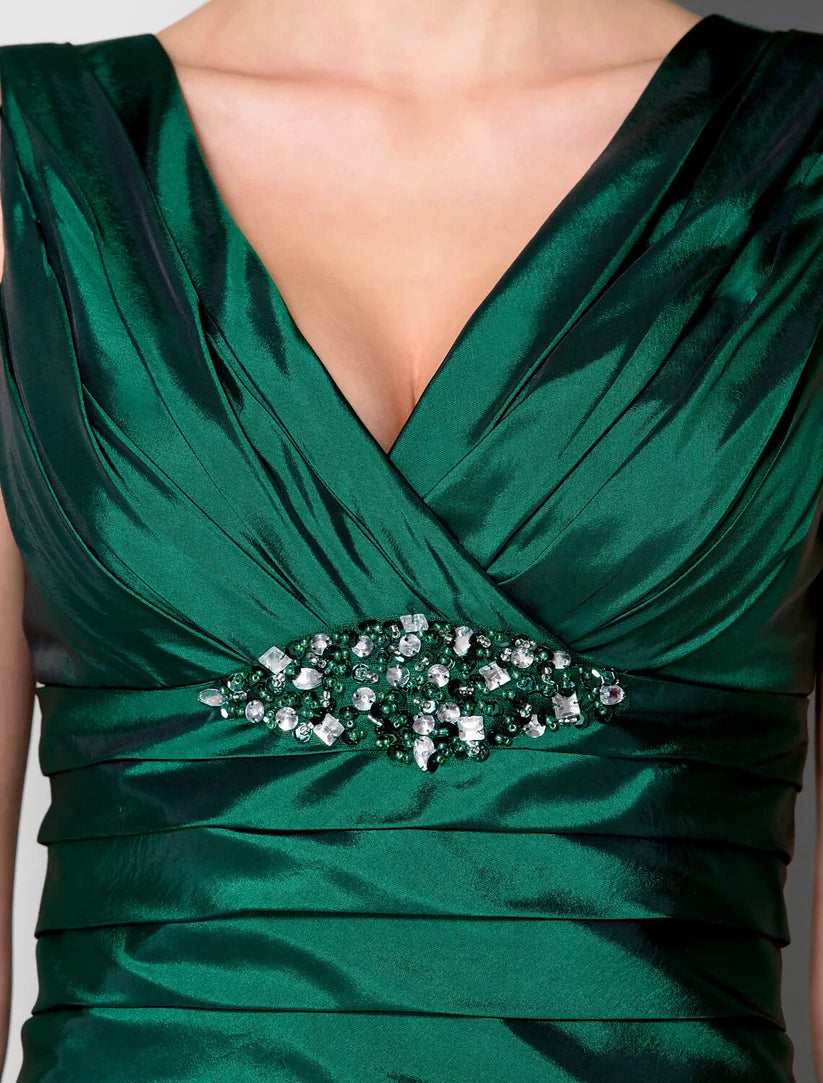 Detail of the criss-cross ruched waist and crystal accents on the formal taffeta dress.
