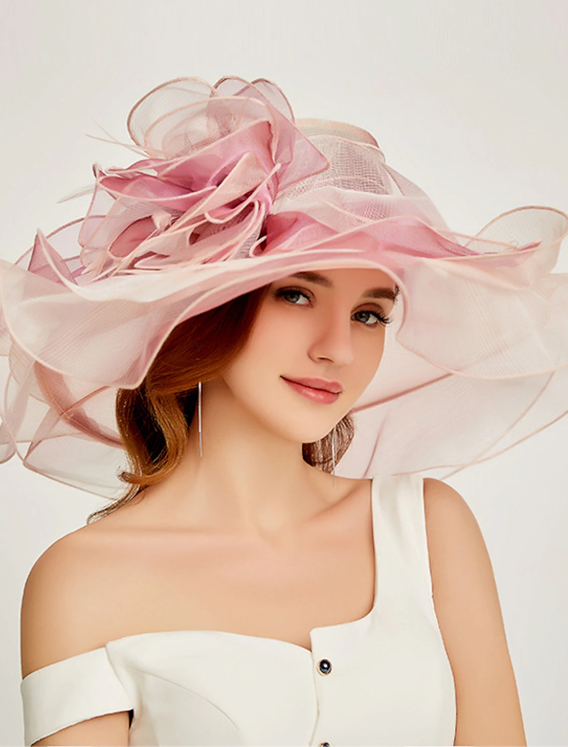 Elegant tiered organza Kentucky Derby hat with a wide brim.