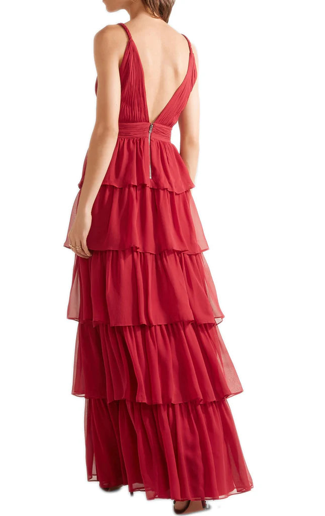 Back view of a woman in a long tiered chiffon formal evening gown.
