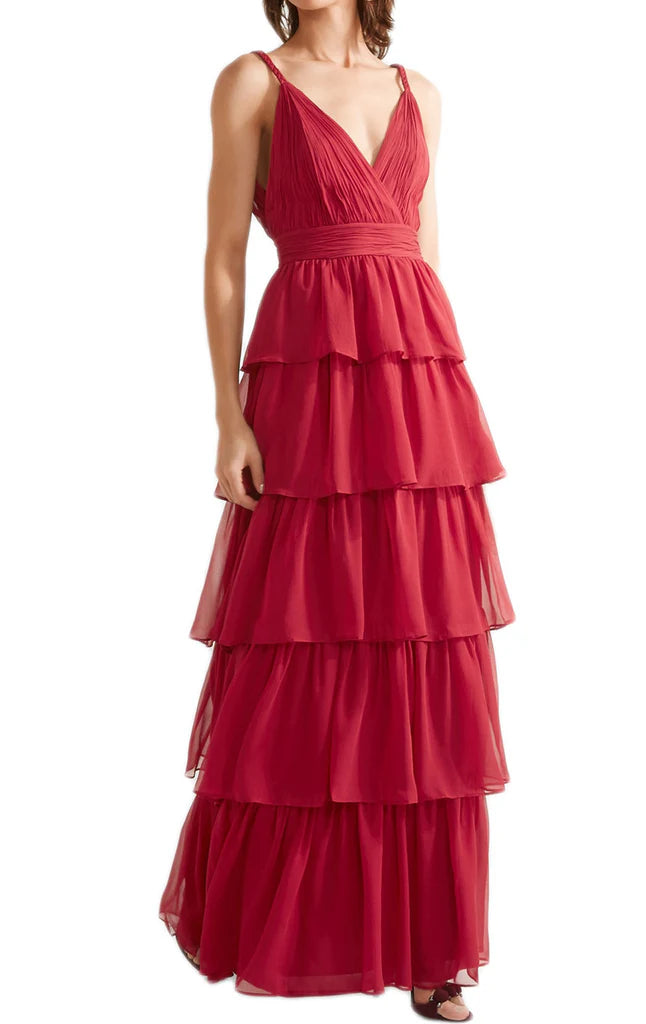 Side view of a woman showcasing the tiered skirt of a V-neck chiffon dress.