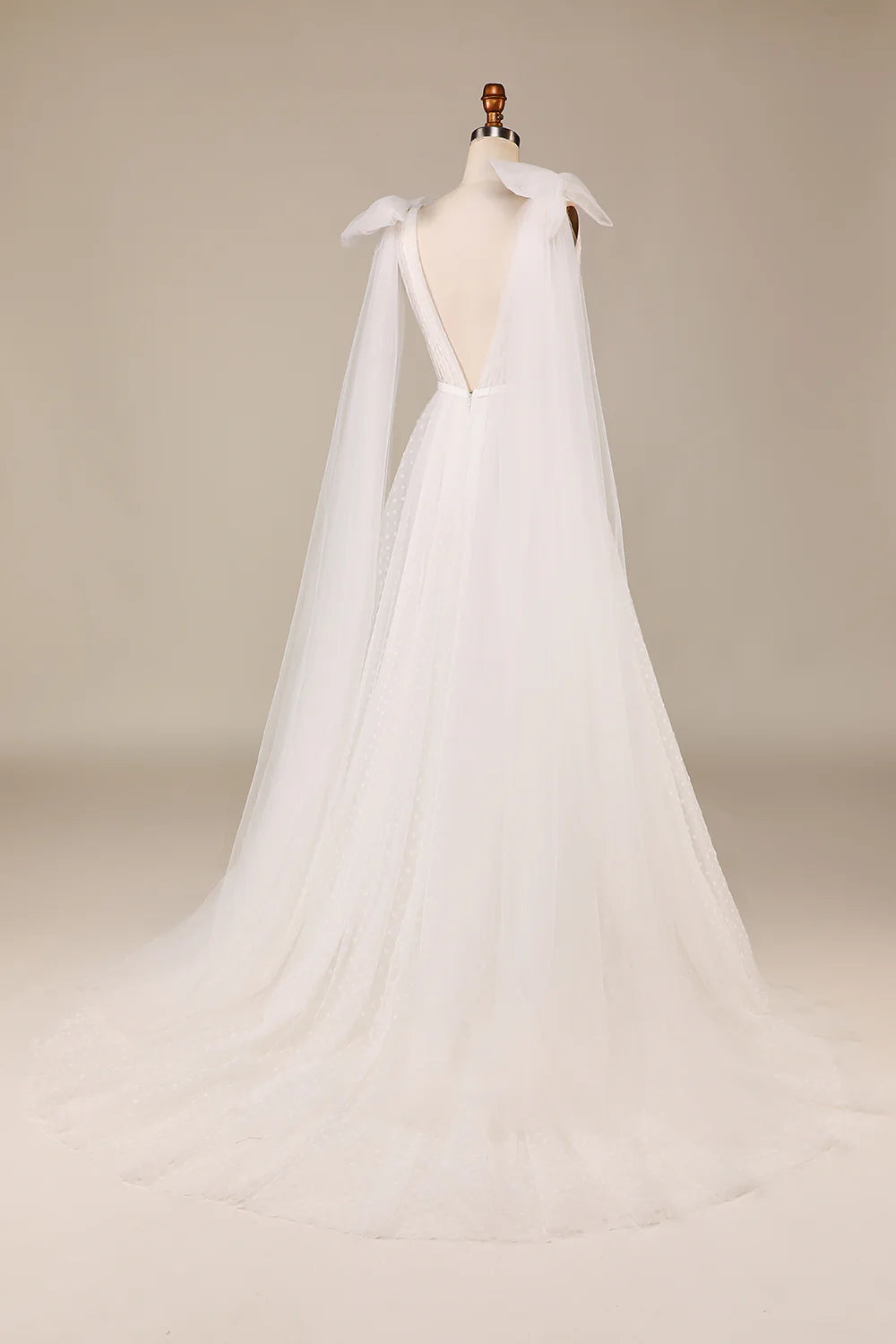 Back view of the ivory tulle wedding dress, showcasing the bowknot and flowing A-line skirt.