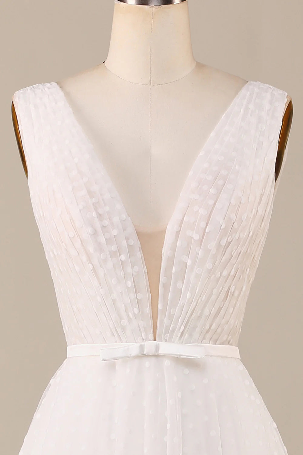 Side profile of the ivory wedding gown, highlighting the deep V-neckline and delicate tulle fabric.