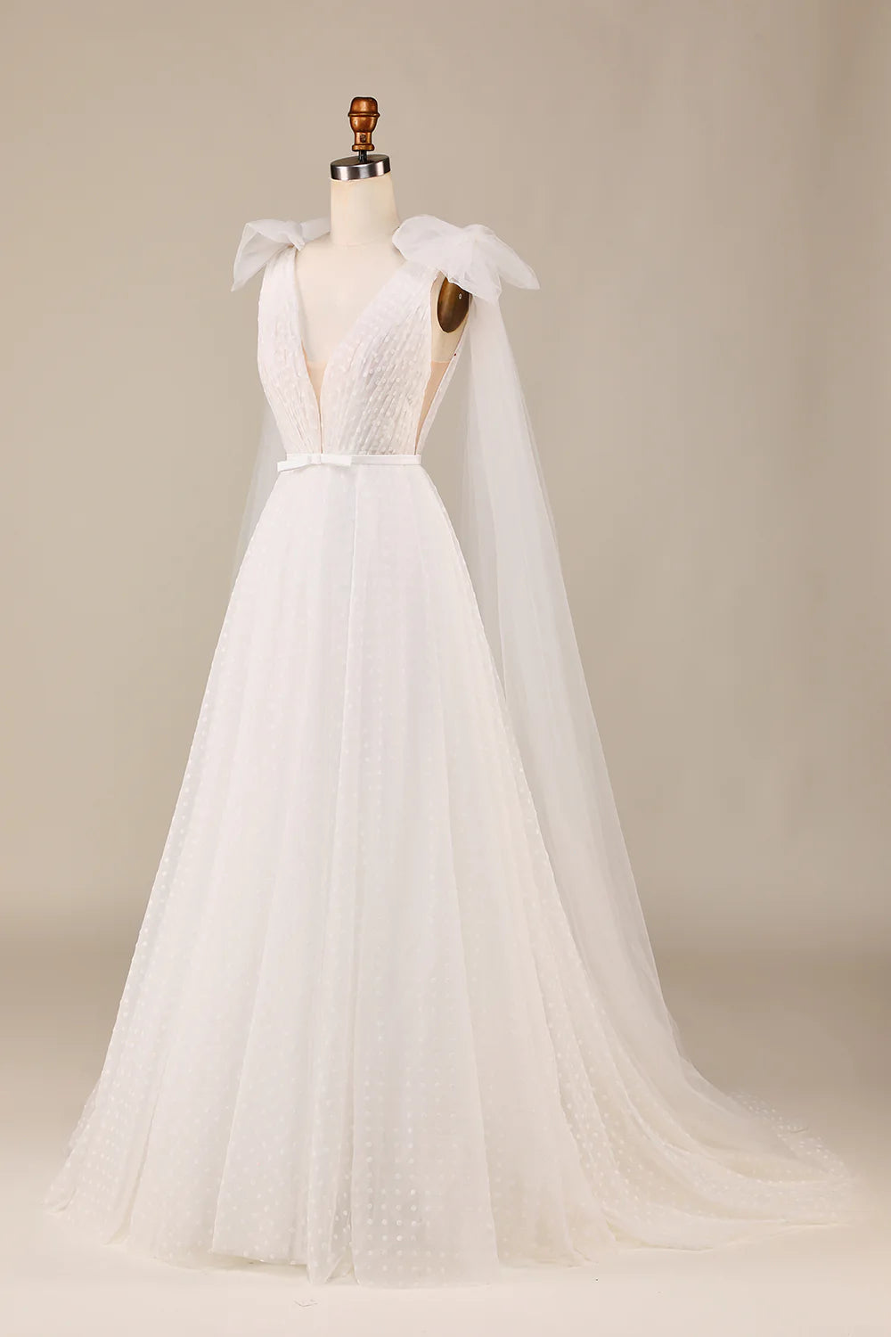 Close-up of the bowknot detail on the ivory tulle wedding dress.