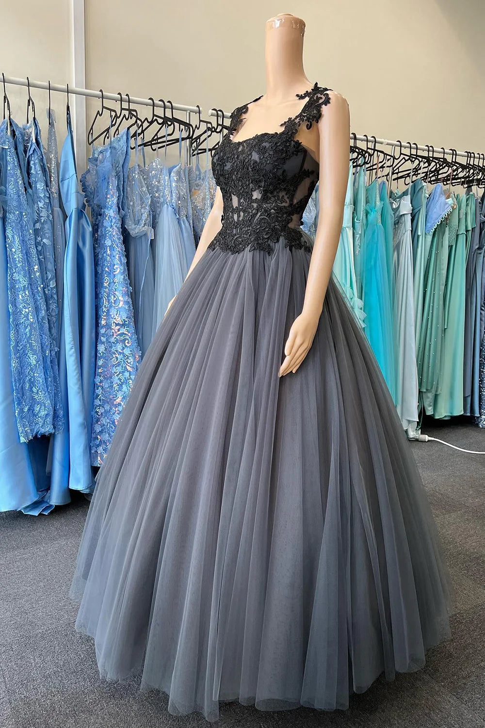 Elegant black tulle corset prom dress with intricate appliques.