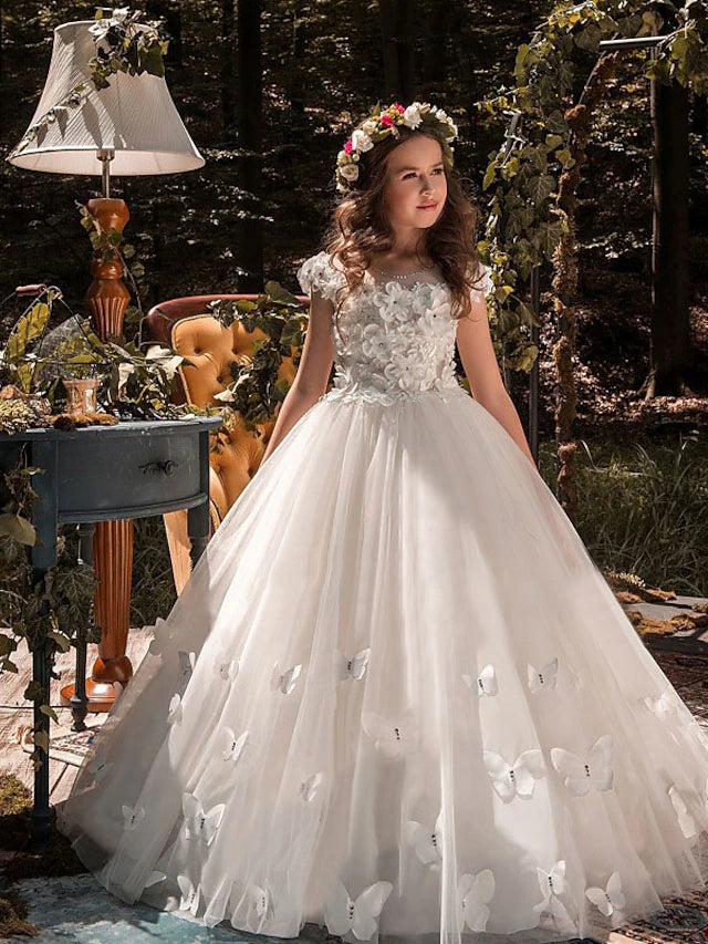 Front view of an elegant white tulle and lace ball gown for a flower girl.