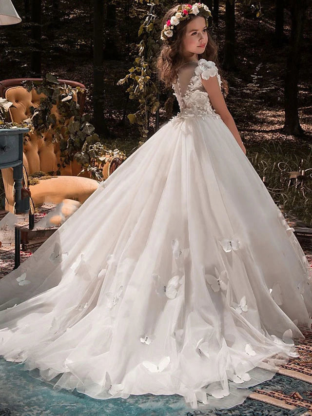 Back view of a white tulle and lace ball gown with a court train.