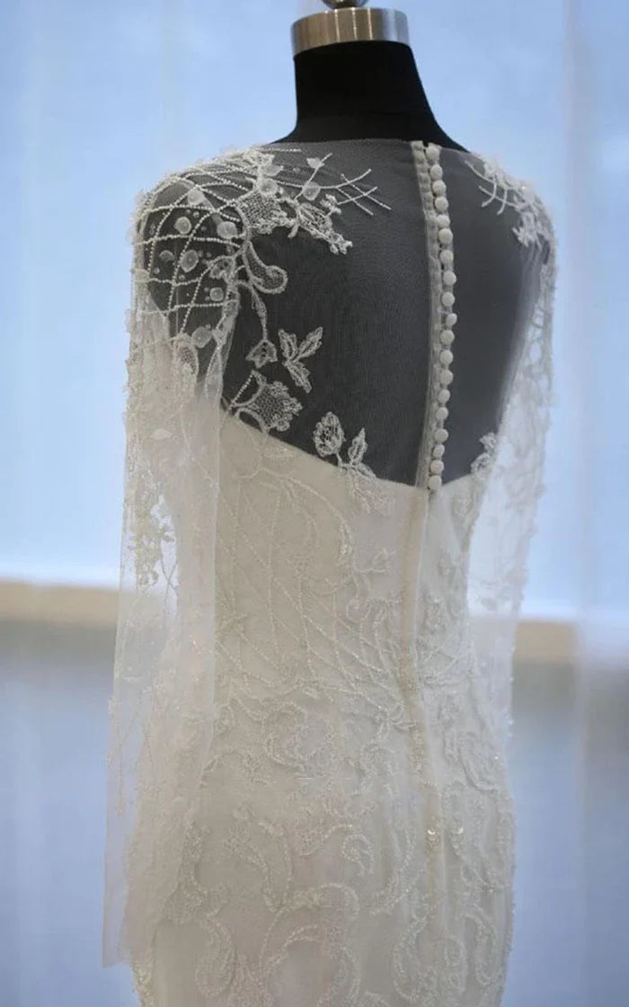 Detail of the bell beading and flower embellishments on the dress sleeve.