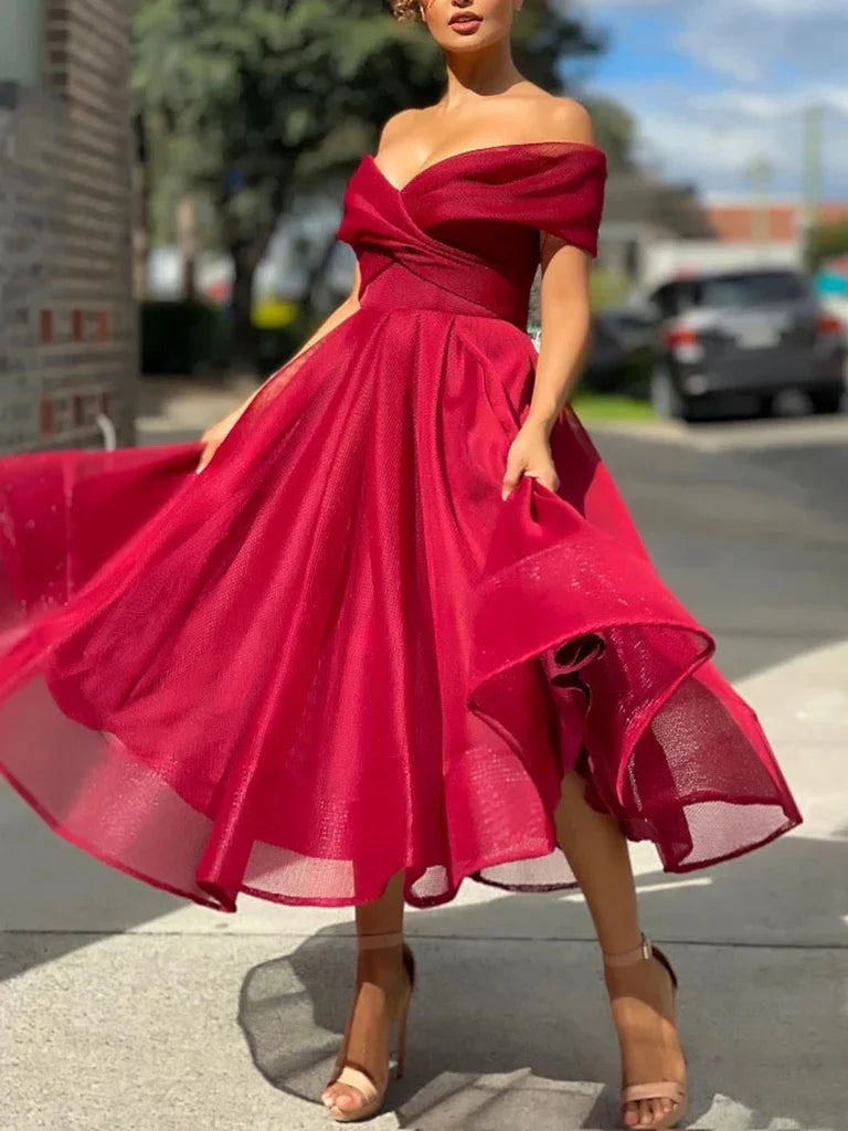Elegant A-line tulle off-shoulder prom dress in a light color.