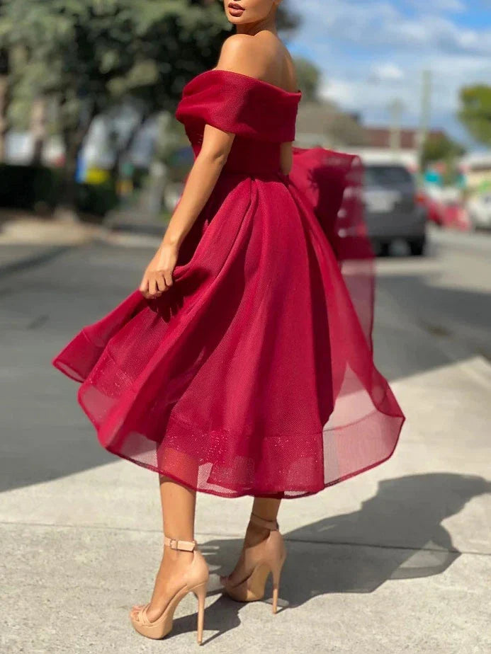 Back view of the graceful A-line tulle off-shoulder gown.