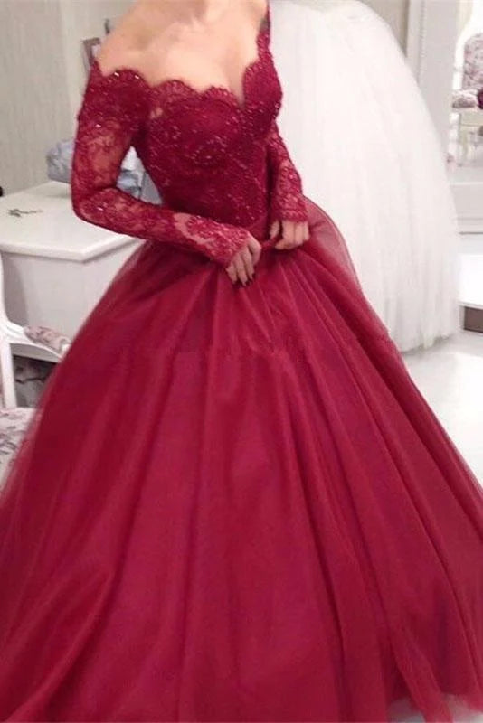 Elegant tulle off-shoulder long sleeve prom dress with applique details.