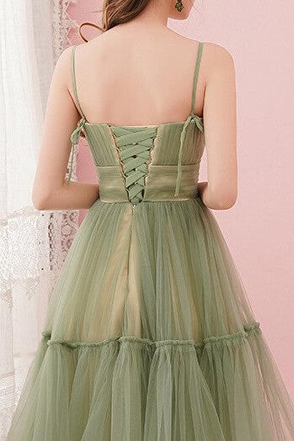 Model wearing a sage green tulle homecoming dress.