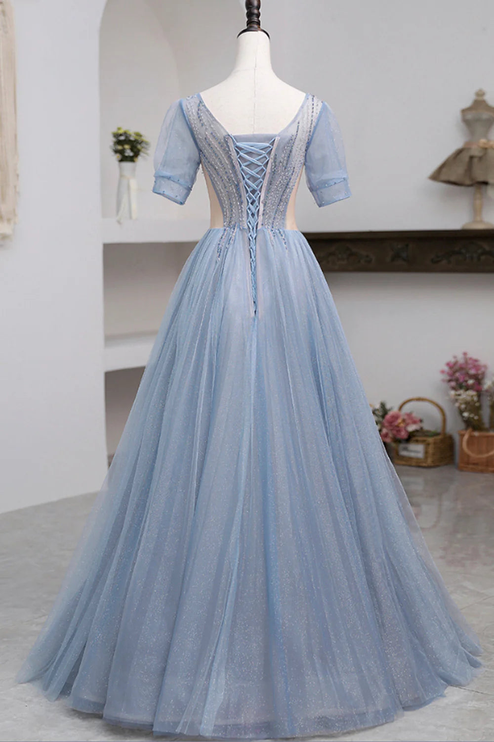 Back view of the light-colored tulle short sleeve prom dress.