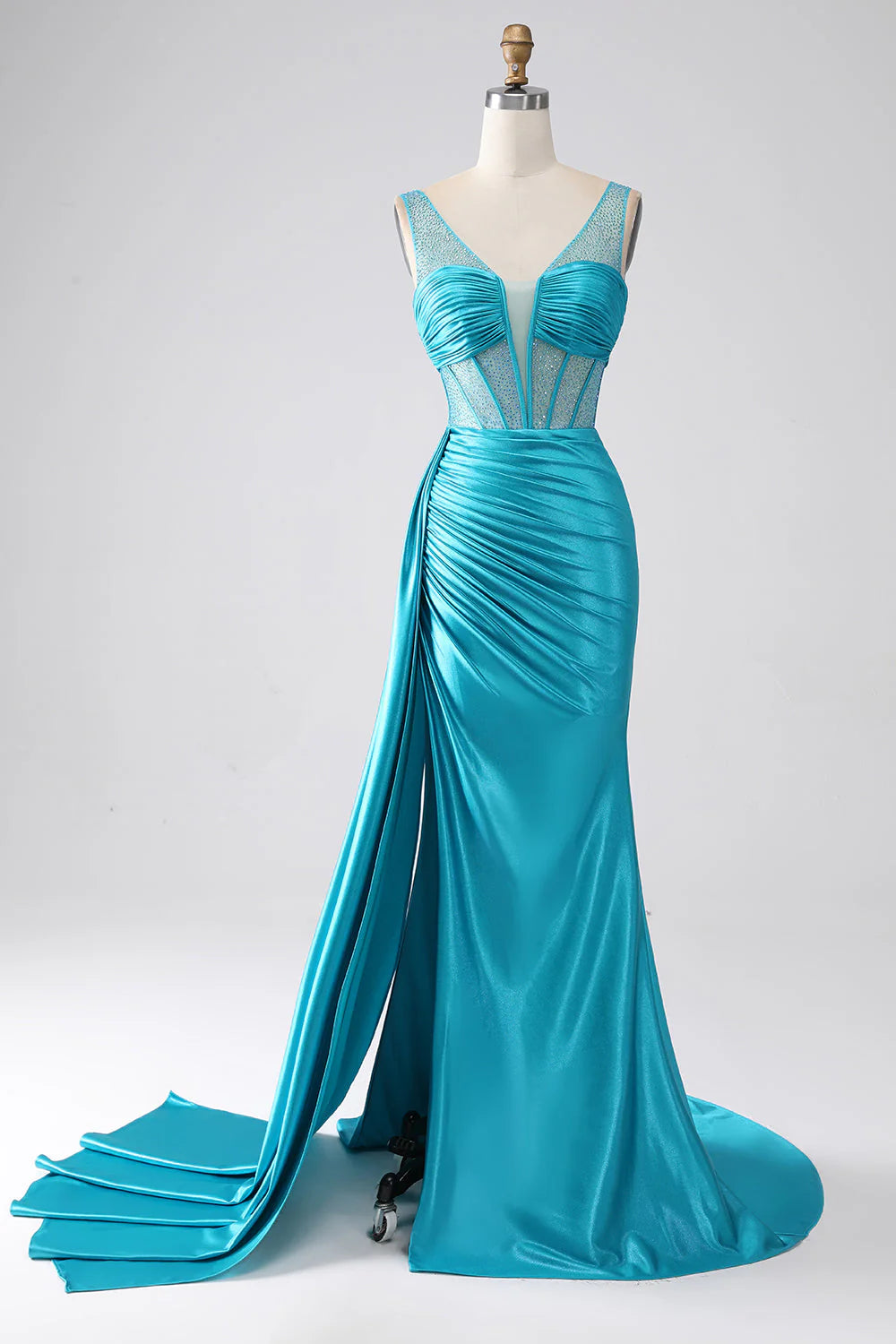 Turquoise mermaid prom dress with V-neck, pleated corset, and intricate beading.