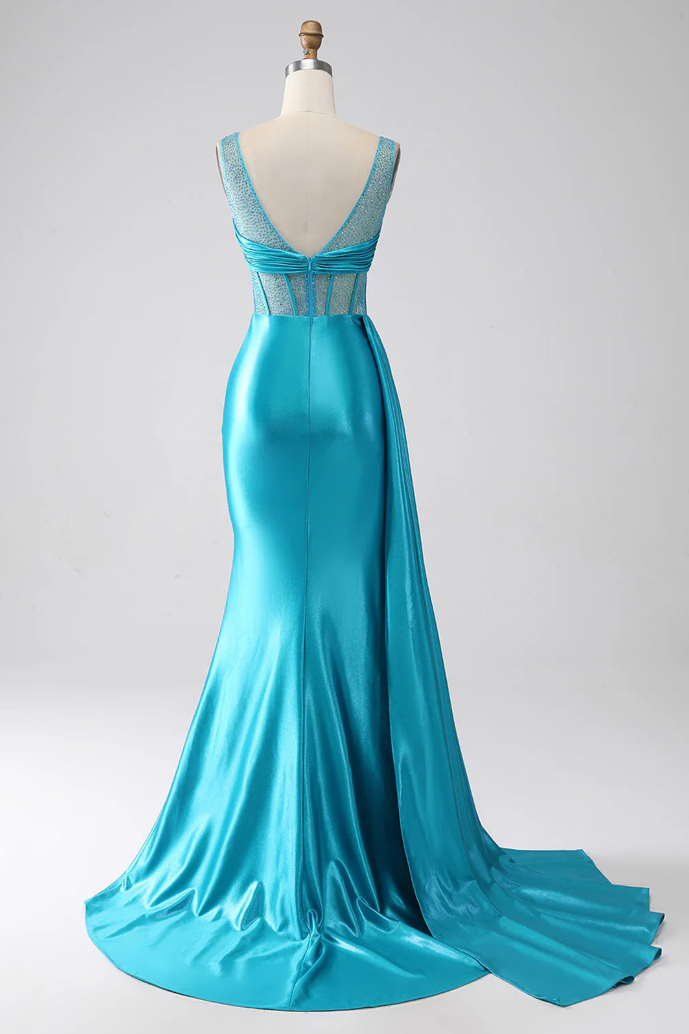 Back view of a turquoise mermaid prom dress showing the sweep train.