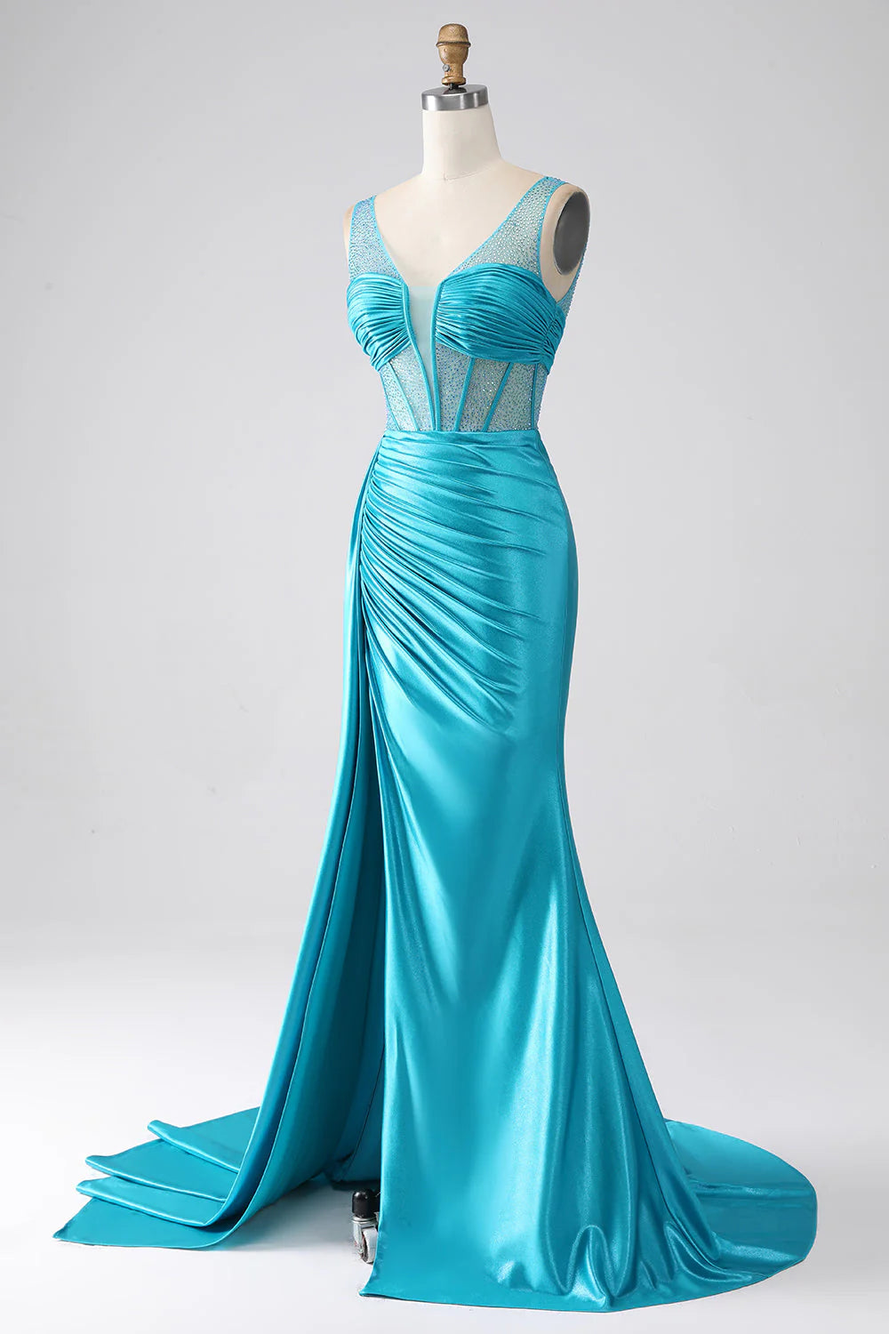 Close-up of the beaded and pleated corset on a turquoise prom dress.