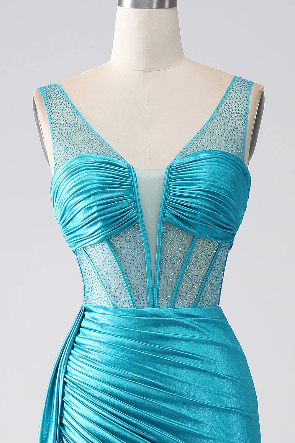 Full-length view of a model wearing a turquoise mermaid prom dress.