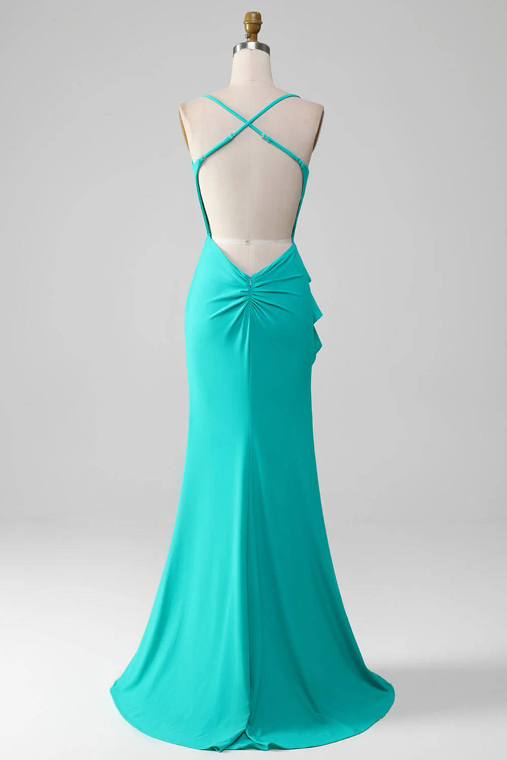 Back view of turquoise mermaid dress with open back and pleats.