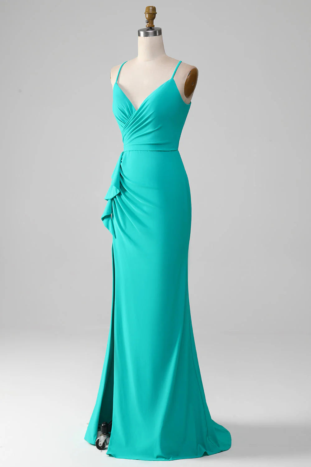 Side profile of turquoise mermaid gown with spaghetti straps.