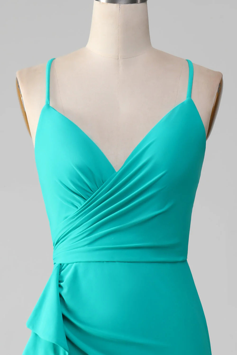 Close-up of pleated detail on turquoise mermaid dress.