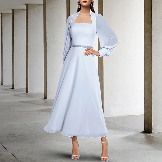 Close-up of the square neckline and short sleeve detail on the chiffon dress.