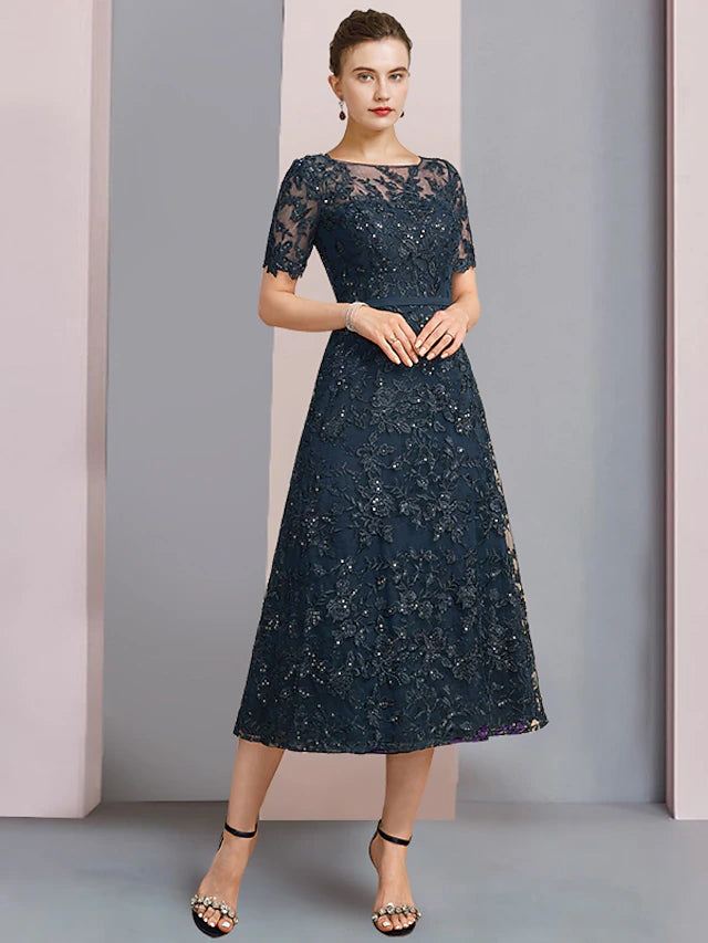 Close-up of delicate lace and sequin appliques on the short sleeve dress.