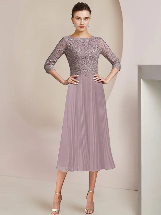 Back view of the tea length mother of the bride dress showing pleats and appliques.