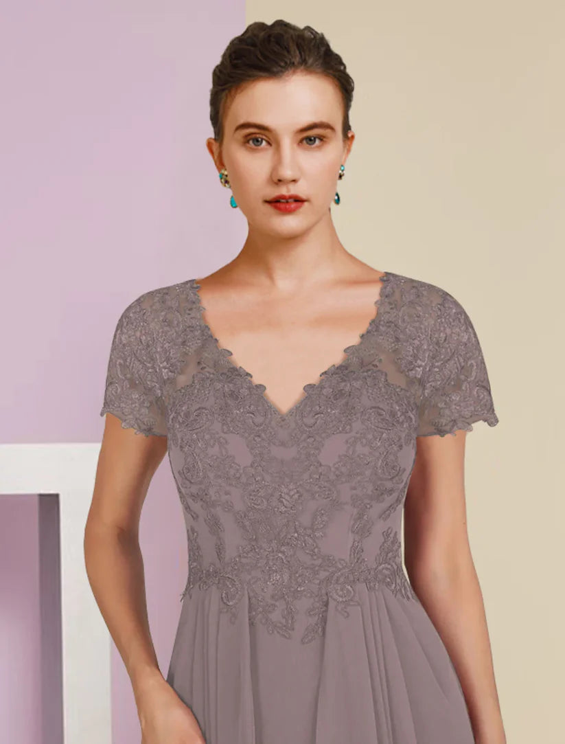 Detail of the V-neckline and intricate lace appliques on the short sleeve formal gown.