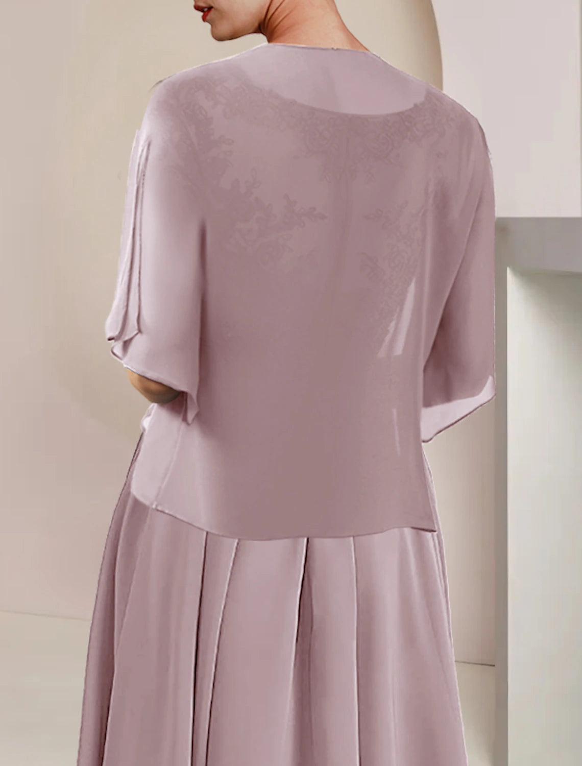 Close-up of lace appliques and chiffon fabric on the elegant dress.