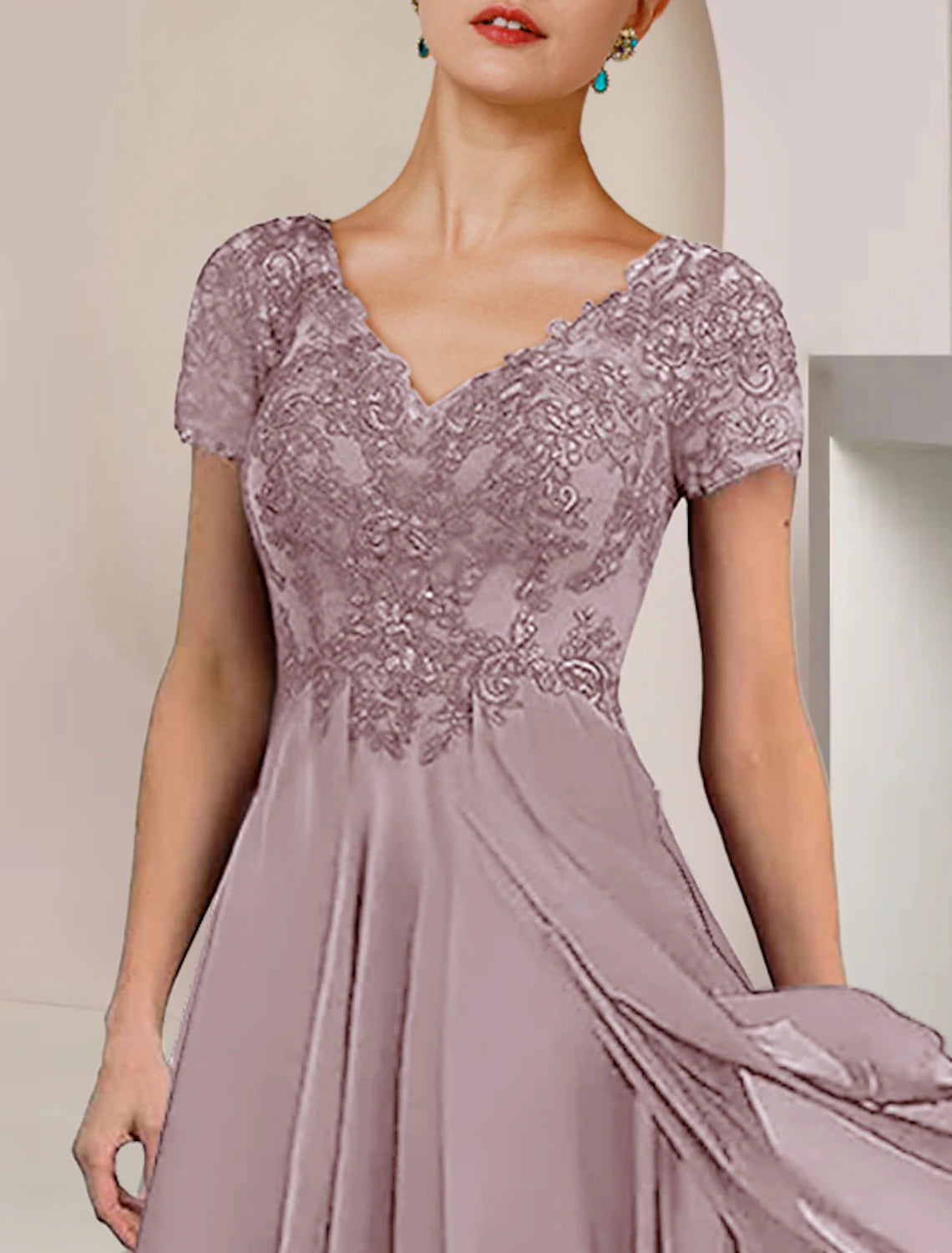 Elegant formal dress with pleats and appliques, suitable for special occasions.