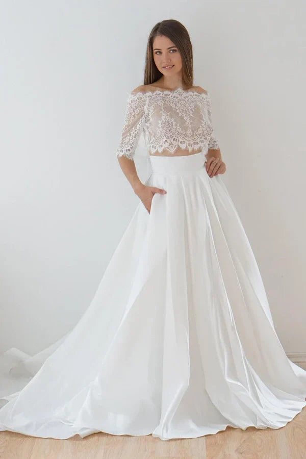 Model wearing an elegant two-piece A-line off-shoulder lace and satin wedding dress.