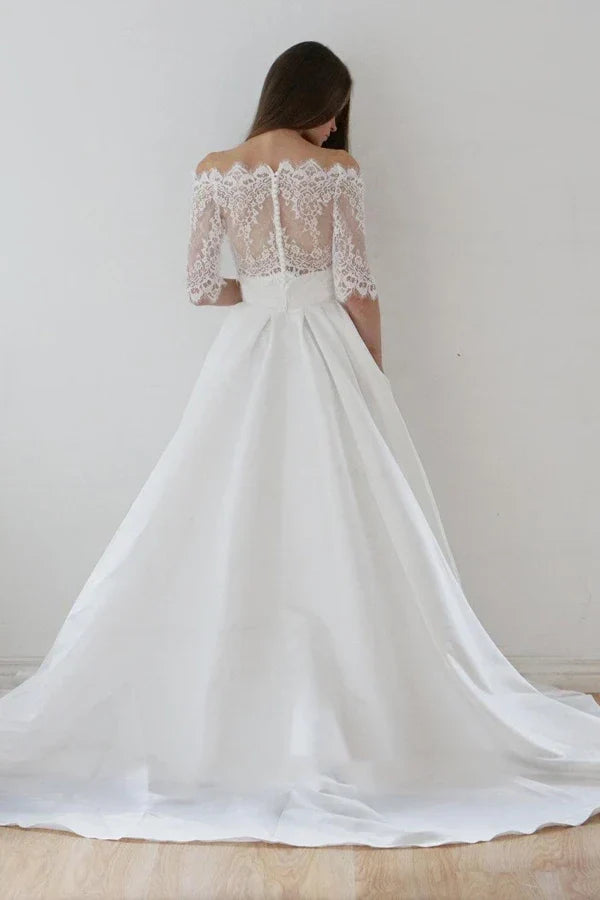 Back view of the two-piece wedding dress, highlighting the sweep train and satin skirt.