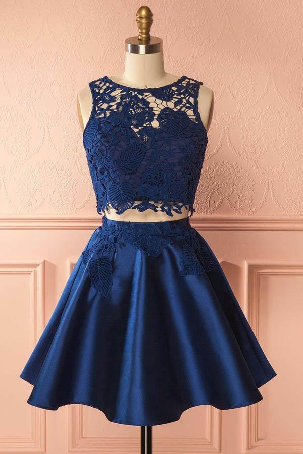 Close-up of lace appliques on a dark blue satin homecoming dress.