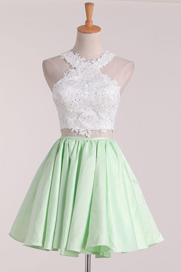 Two-piece A-line satin homecoming dress with scoop neckline and applique detail.