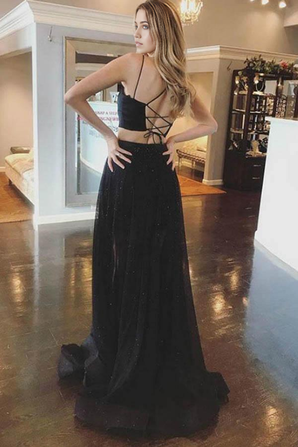 Full view of the black two-piece A-line prom dress with flowing skirt.
