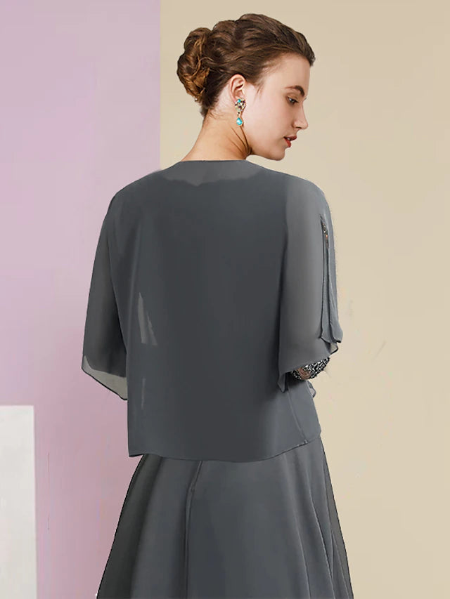 Back view of the two-piece A-line formal dress, showing tea length and ruched appliques.