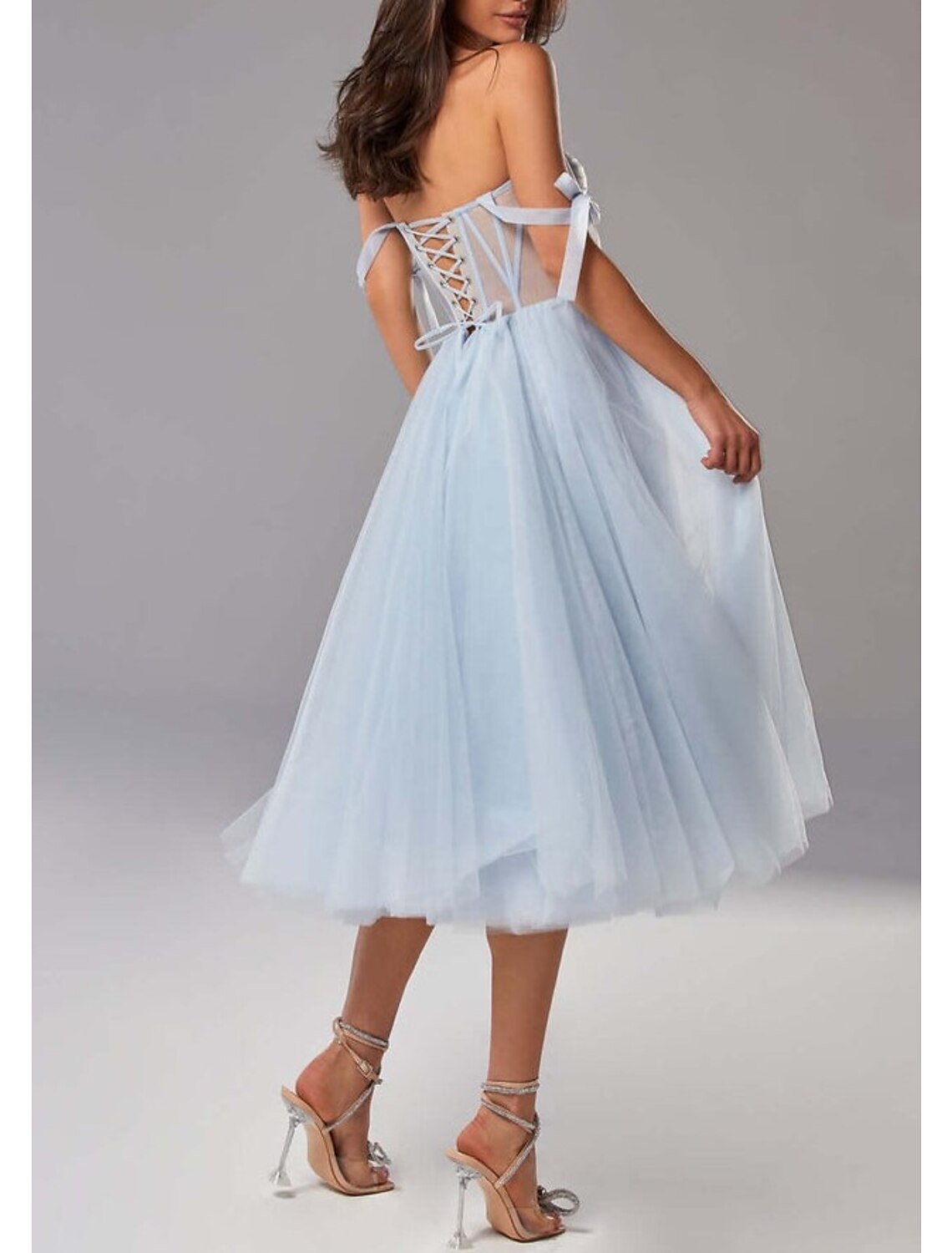Model showcasing the tea-length prom dress.