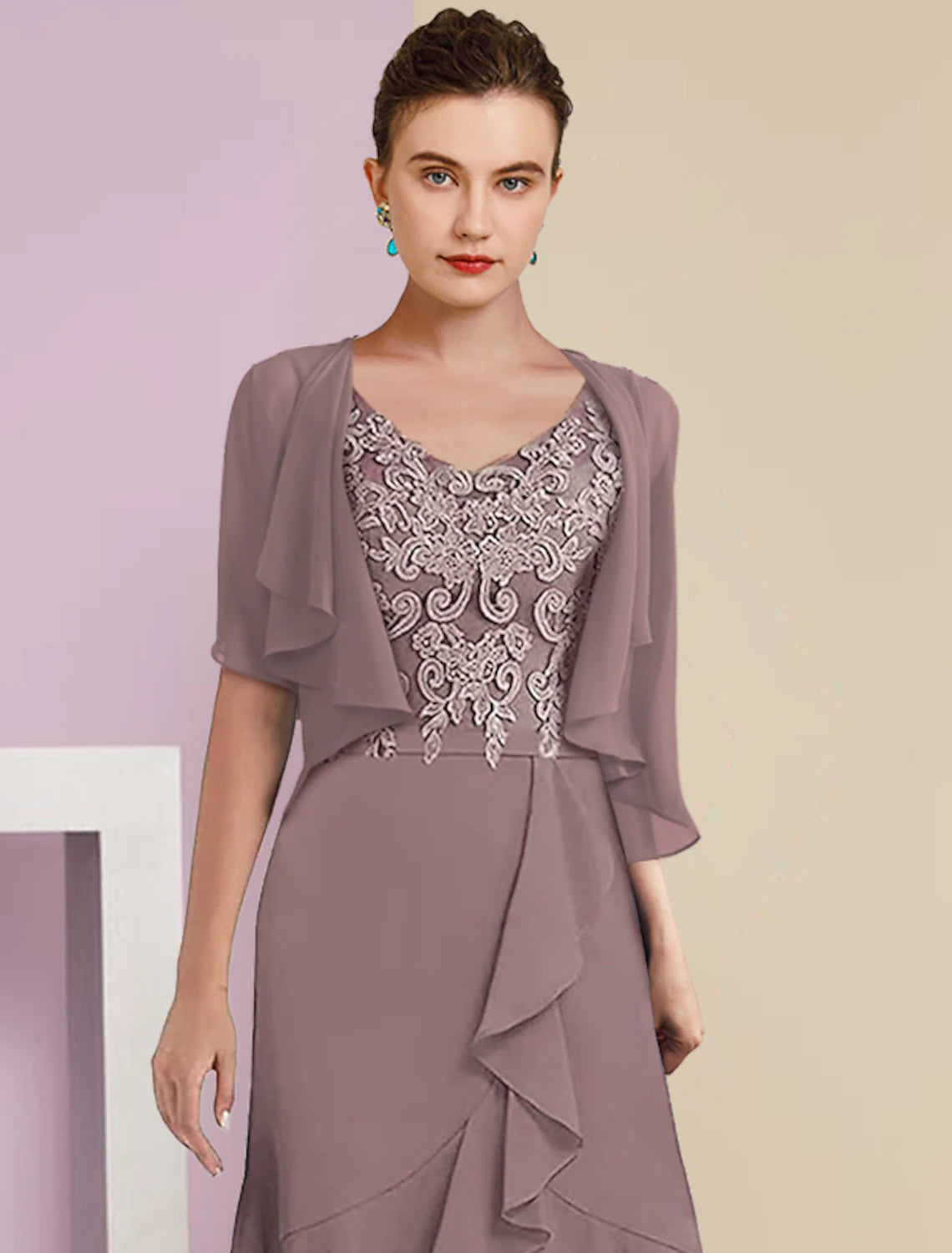 Close-up of the V-neckline and delicate lace appliques on the two-piece dress.