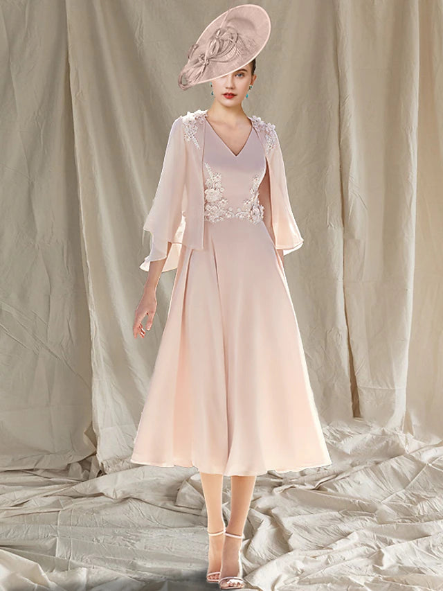 Woman wearing an elegant two-piece A-line V-neck tea length chiffon dress with a matching wrap.