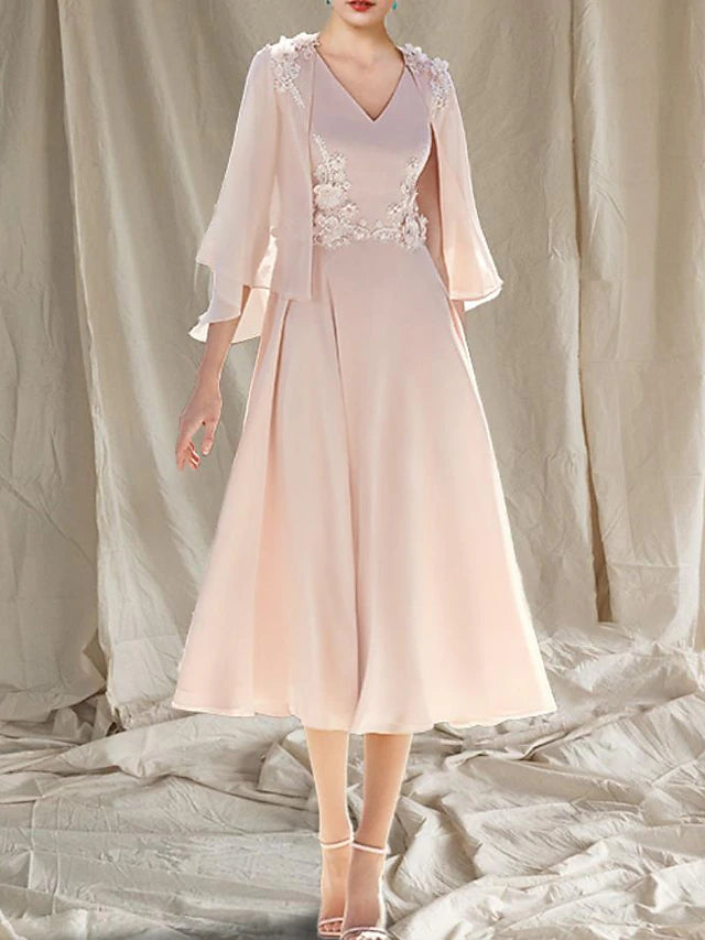 Close-up of the elegant two-piece A-line V-neck tea length chiffon dress, showing appliques.
