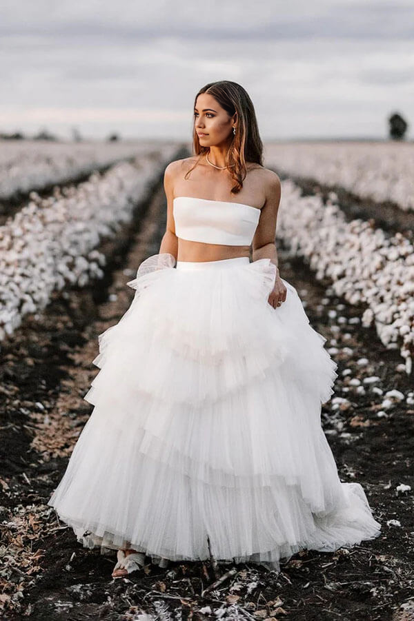 Bride wearing a two-piece V-neck country wedding dress with a layered A-line skirt.