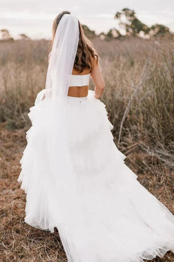 Back view of a two-piece country wedding dress, showing the flowing layered skirt.