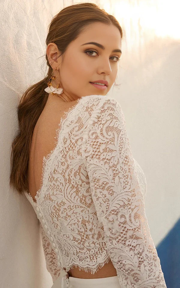 Close-up of the lace bodice and ruched detailing on a two-piece wedding dress.